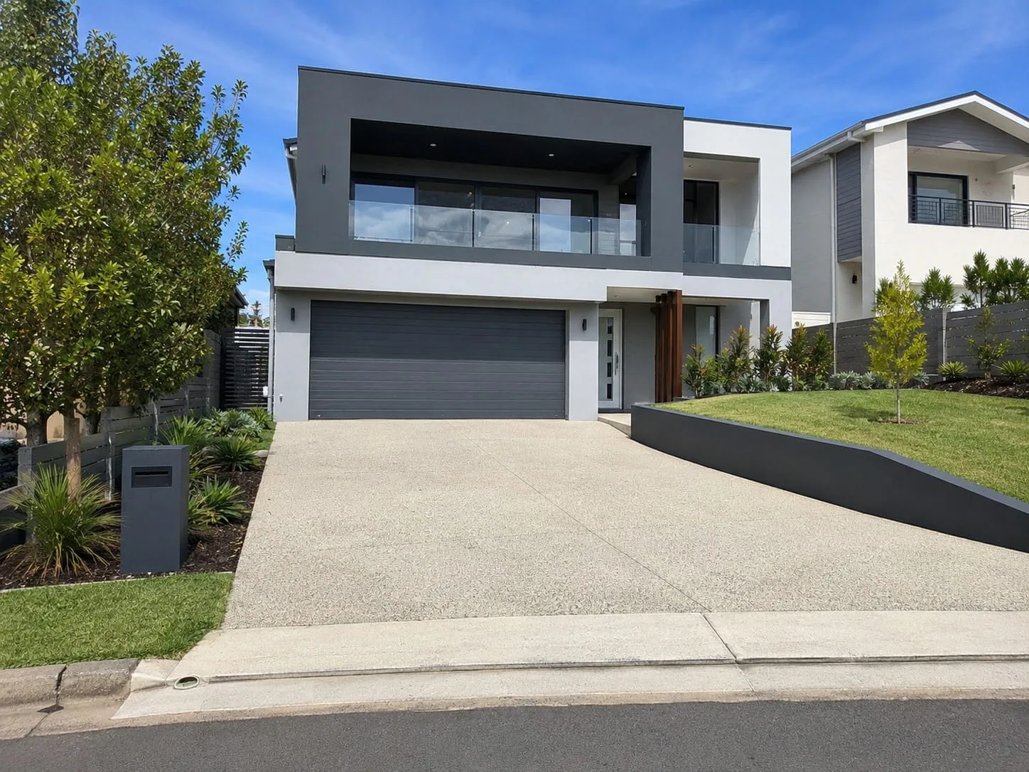 Newly replaced concrete driveway and crossover at a contemporary two-storey Newcastle home